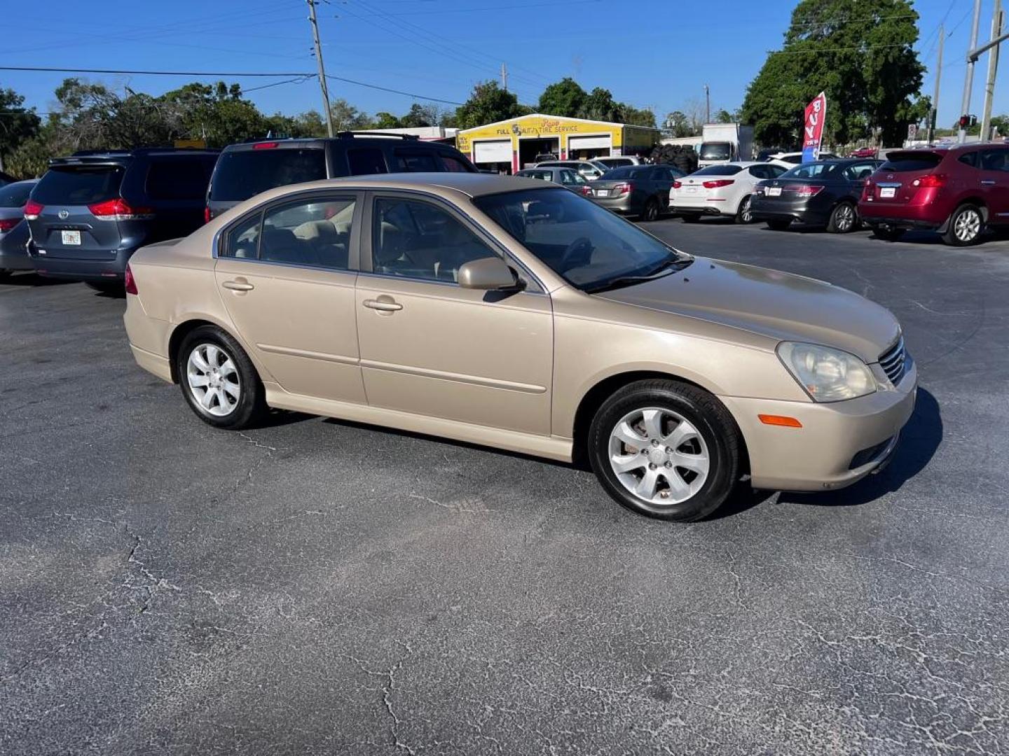 2008 GOLD KIA OPTIMA LX (KNAGE124385) with an 2.7L engine, Automatic transmission, located at 2929 9th St. West, Bradenton, 34205, (941) 242-2810, 27.473591, -82.570679 - Photo#1